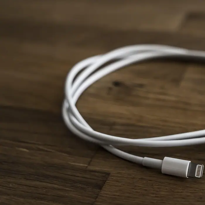 A coiled white charging cable