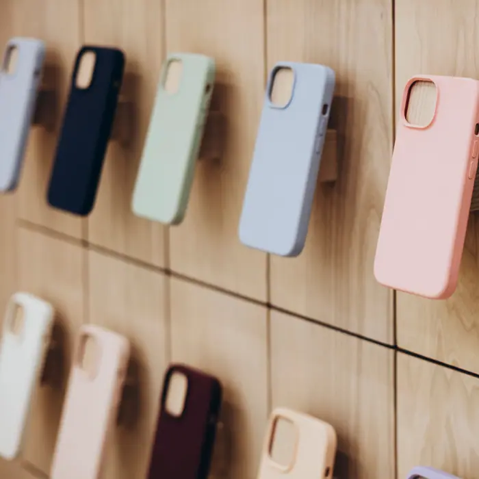 A row of blank phone cases in assorted colours on display